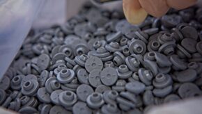 A bag of grey drug product vial caps